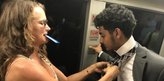 Fellow Passenger Helps Young Man With His Tie On Train